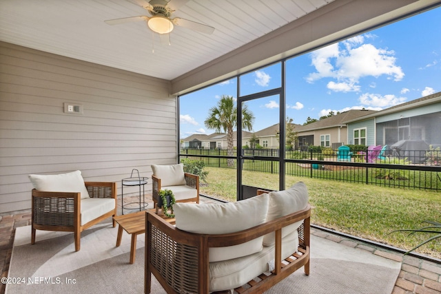 sunroom / solarium featuring ceiling fan