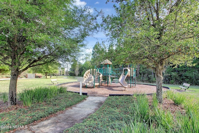 view of playground with a lawn