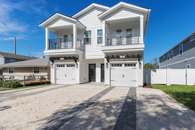 view of front of home with a balcony and a garage