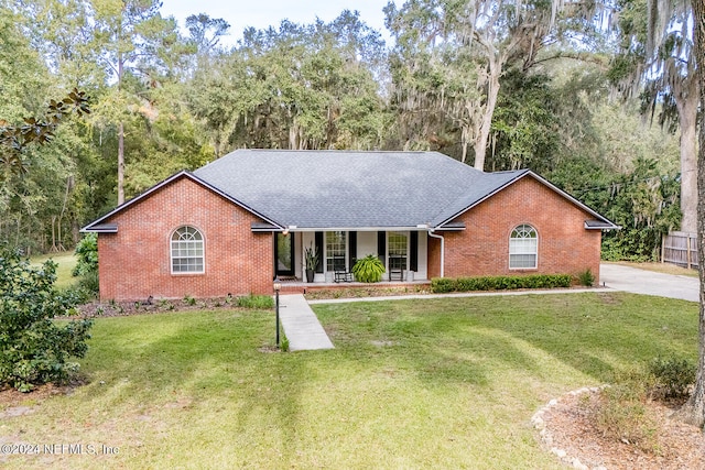 ranch-style home with covered porch and a front lawn