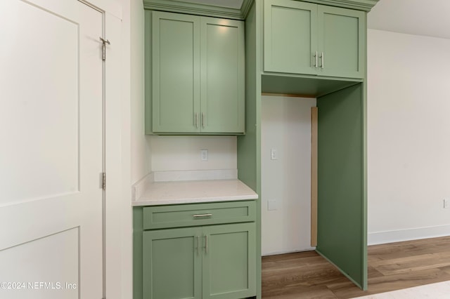 kitchen with hardwood / wood-style flooring and green cabinets