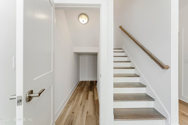 stairs featuring hardwood / wood-style flooring