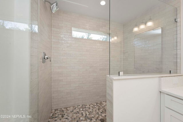 bathroom featuring vanity and tiled shower