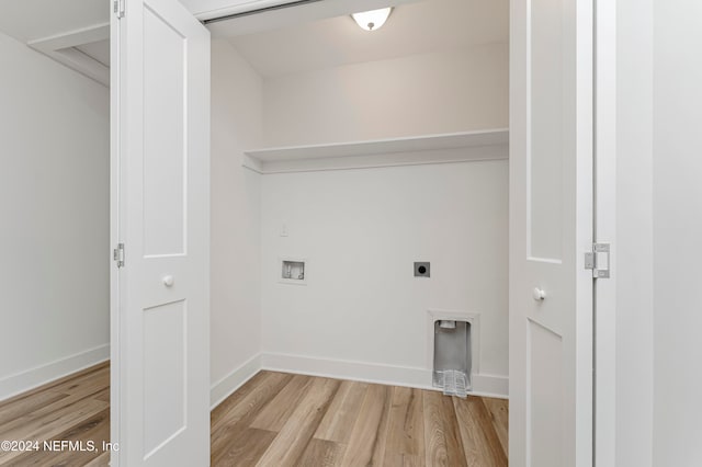 clothes washing area featuring hookup for an electric dryer, washer hookup, and light wood-type flooring