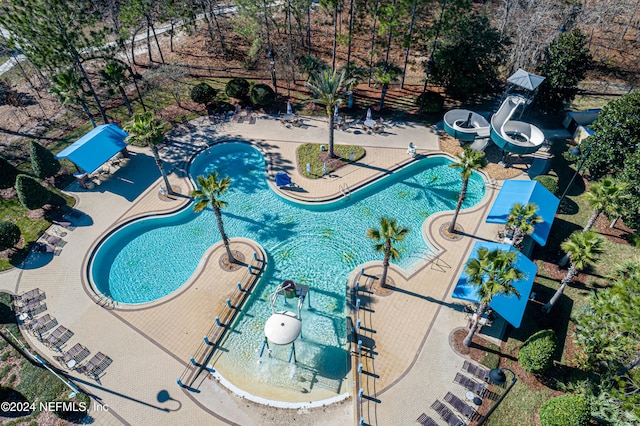 view of swimming pool with a water slide