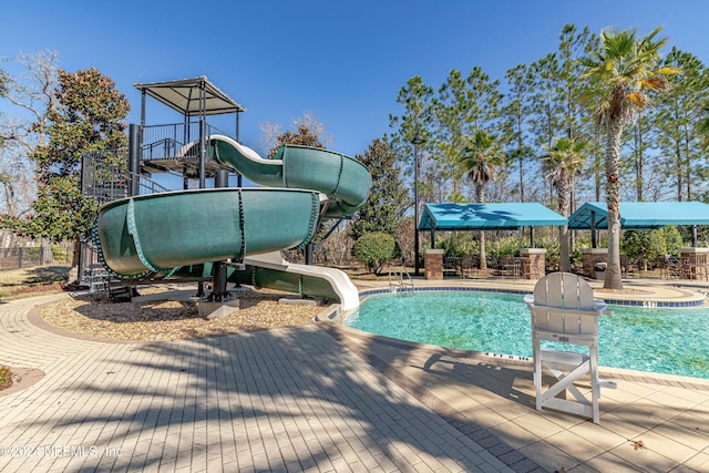 view of swimming pool with a water slide