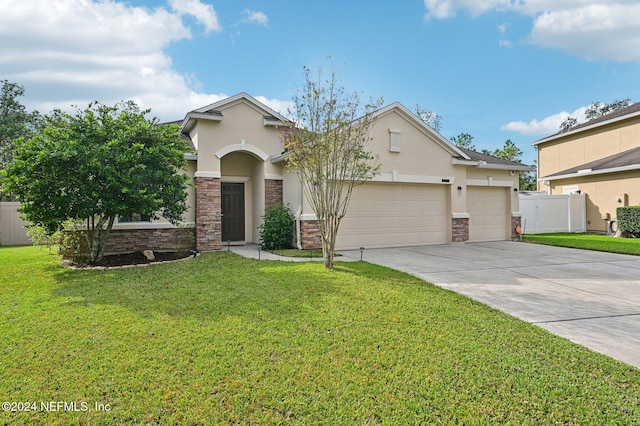 view of front of property with a garage and a front lawn