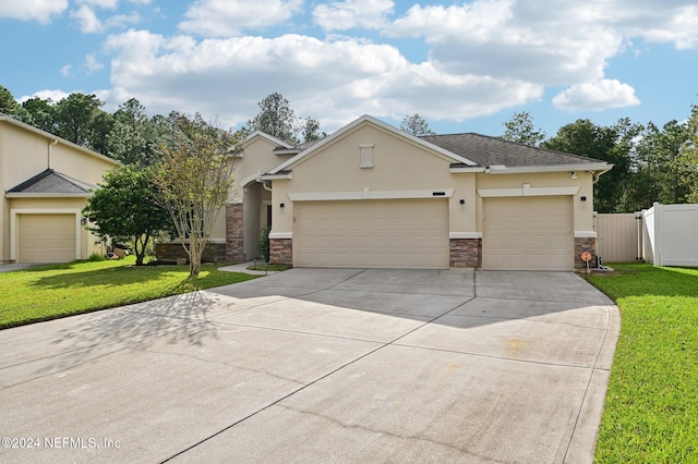 view of front of home featuring a front yard and a garage