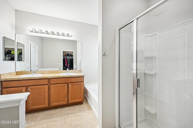 bathroom with tile patterned floors, separate shower and tub, and vanity