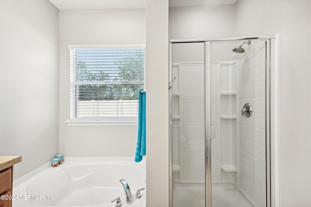 bathroom featuring shower with separate bathtub and vanity