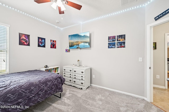 carpeted bedroom featuring ceiling fan