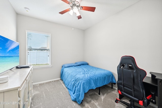 bedroom featuring light colored carpet and ceiling fan