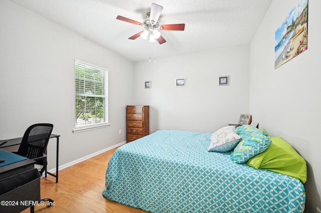 bedroom with ceiling fan and wood-type flooring