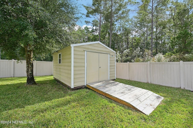 view of outbuilding featuring a yard