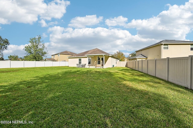 view of yard with ceiling fan and a patio area