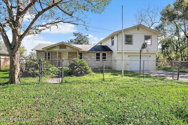 view of front of property with a garage and a front yard