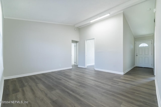 empty room with beam ceiling, dark hardwood / wood-style floors, high vaulted ceiling, and crown molding