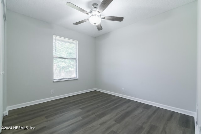 unfurnished room with ceiling fan, dark wood-type flooring, and a textured ceiling