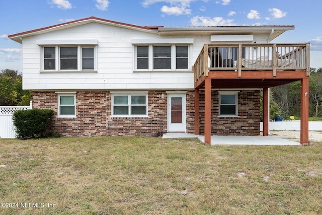 view of front of house with a patio, a front yard, and a deck