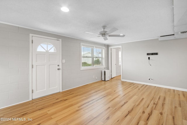 foyer entrance with crown molding, light hardwood / wood-style floors, a textured ceiling, and ceiling fan