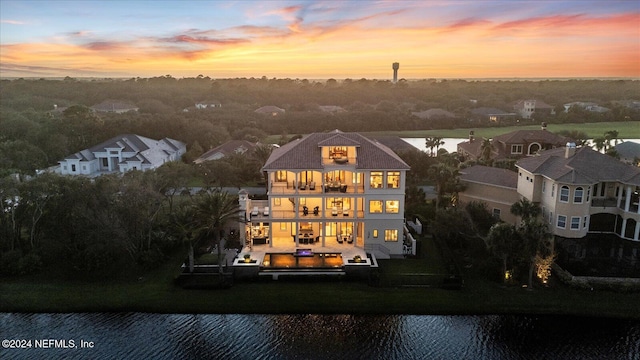 aerial view at dusk with a water view