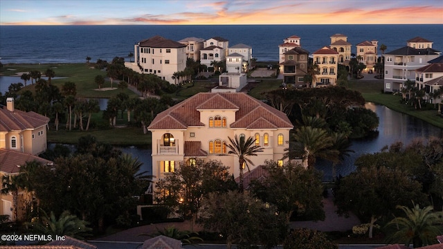 aerial view at dusk with a water view