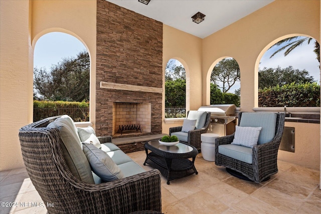 view of patio featuring a grill and an outdoor living space with a fireplace