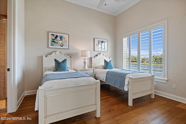 bedroom with ceiling fan, dark hardwood / wood-style flooring, and ornamental molding