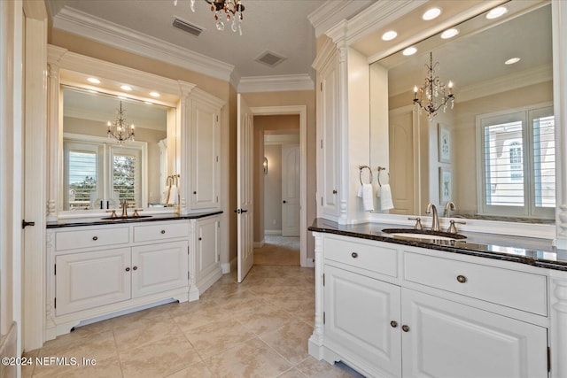 bathroom with tile patterned flooring, vanity, an inviting chandelier, and ornamental molding