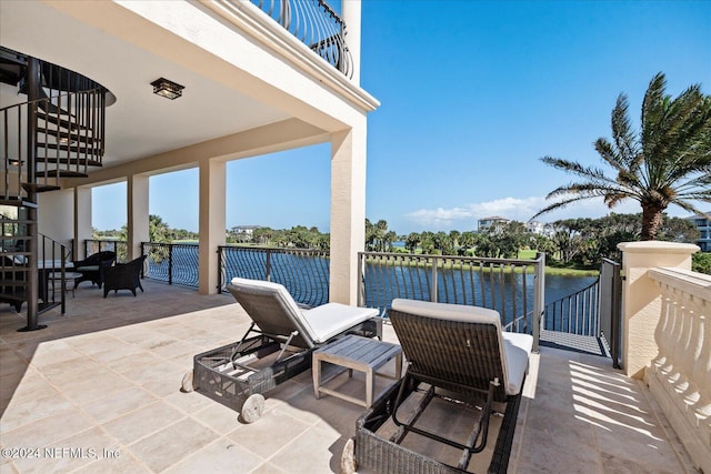 view of patio / terrace with an outdoor hangout area, a water view, and a balcony