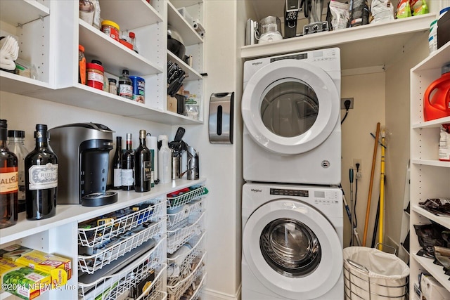 clothes washing area with stacked washer and clothes dryer