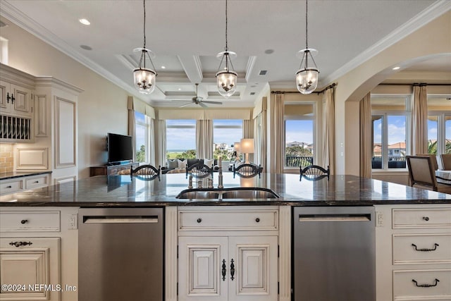 kitchen featuring dishwasher, decorative light fixtures, and a kitchen island with sink