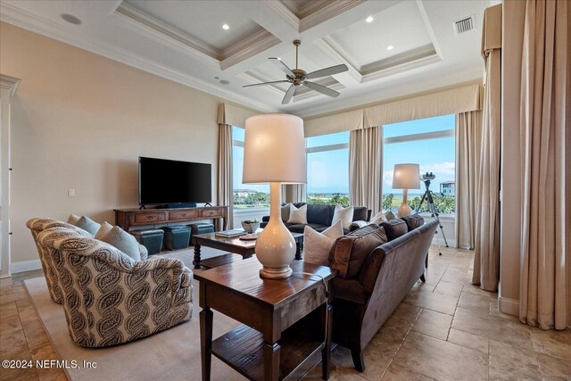 living room with beam ceiling, plenty of natural light, crown molding, and coffered ceiling