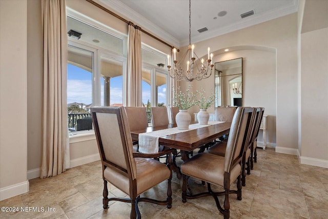 dining area featuring ornamental molding and a notable chandelier