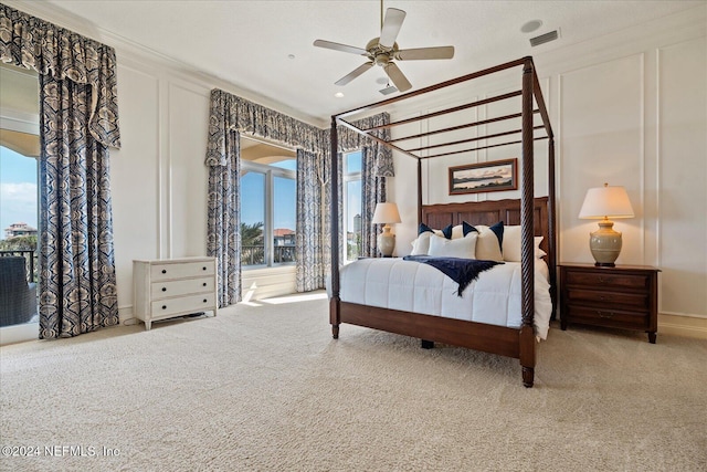 bedroom featuring light carpet, ceiling fan, and crown molding