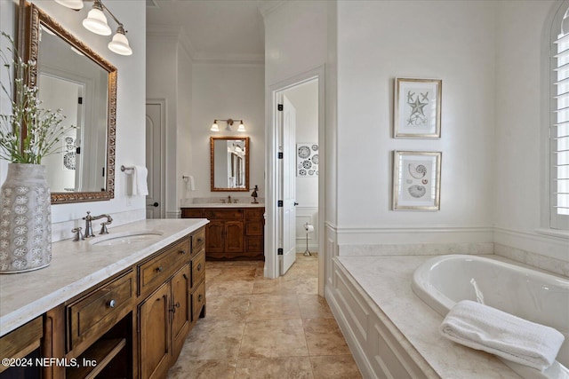 bathroom with a washtub, vanity, and ornamental molding