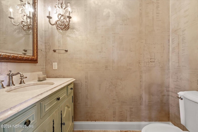 bathroom with toilet and vanity