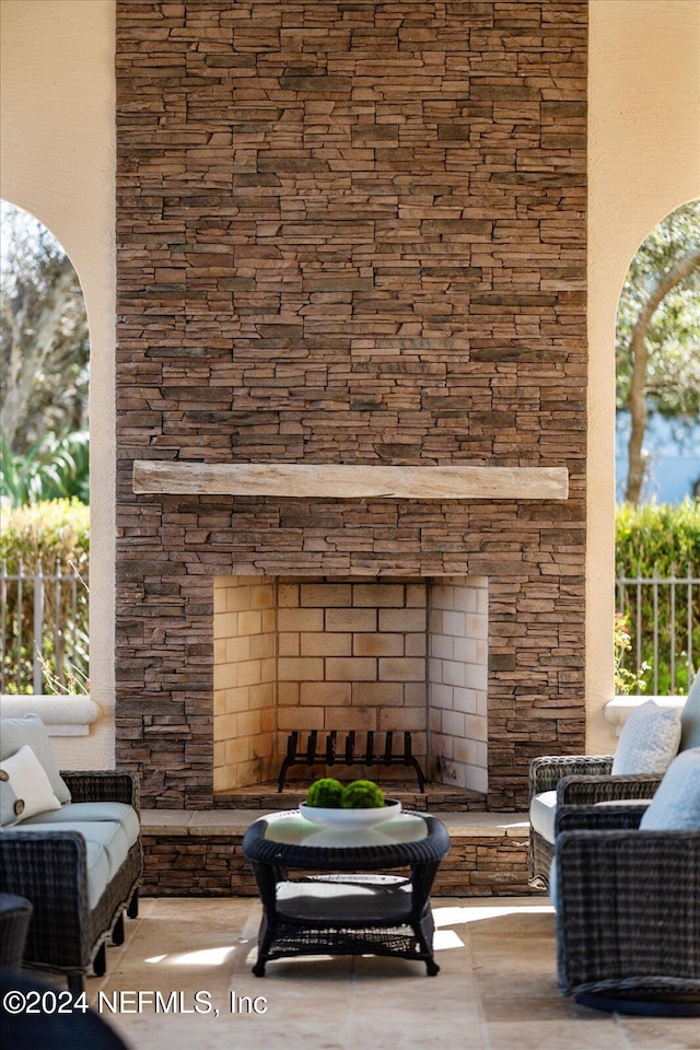 view of patio with an outdoor stone fireplace