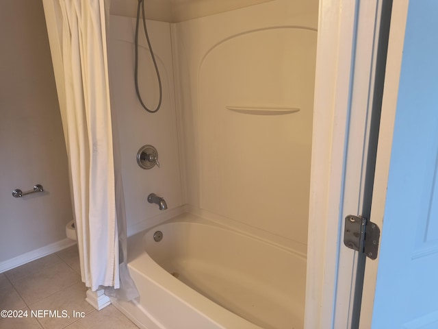 bathroom with tile patterned flooring, shower / bath combo, and toilet