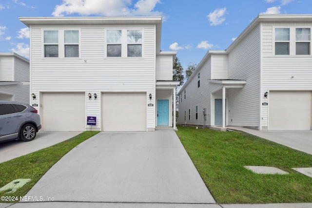 view of front facade with a front yard and a garage