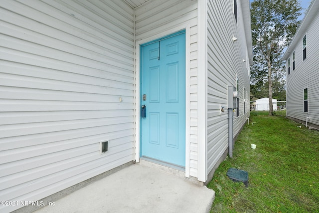 doorway to property featuring a yard