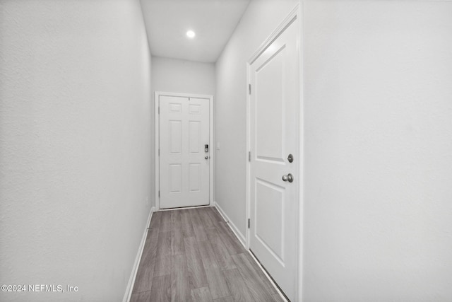 hall with light hardwood / wood-style flooring