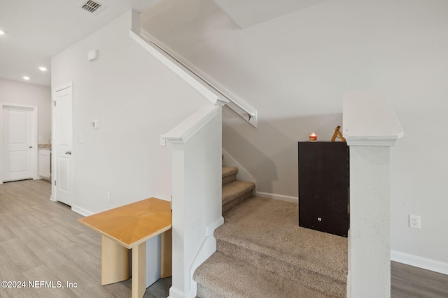 stairway with hardwood / wood-style flooring