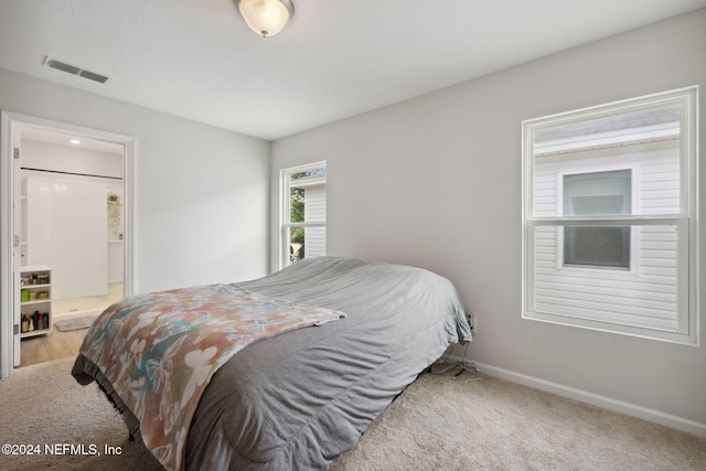 carpeted bedroom with ensuite bathroom