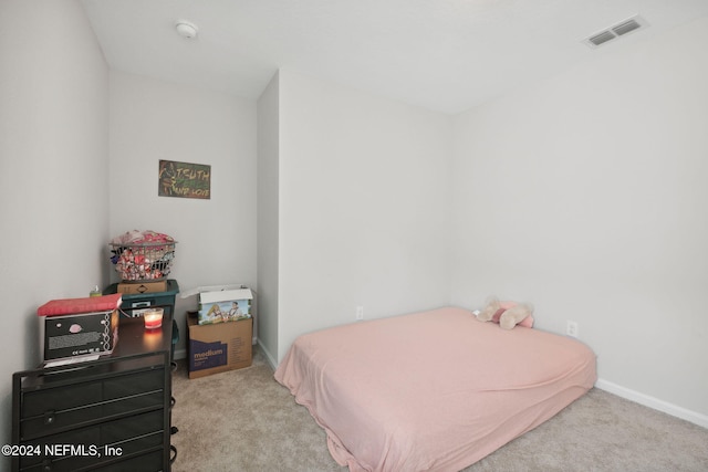 bedroom featuring light colored carpet