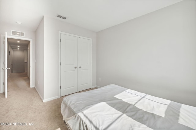 carpeted bedroom with a closet