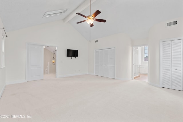 unfurnished bedroom featuring beam ceiling, light colored carpet, visible vents, high vaulted ceiling, and baseboards