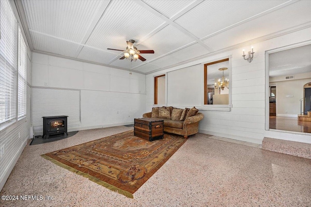 living room with ceiling fan and a wood stove