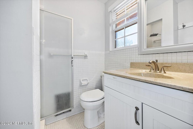 bathroom featuring walk in shower, vanity, tile walls, tile patterned flooring, and toilet