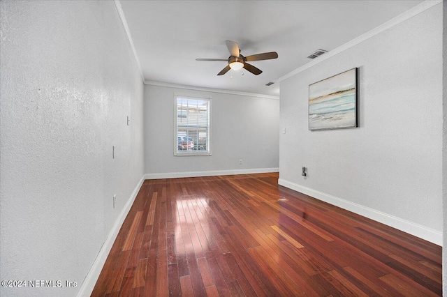 empty room with ceiling fan, dark hardwood / wood-style flooring, and ornamental molding